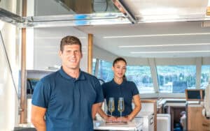 Yacht crew aboard a yacht, awaiting the arrival of guests with champagne