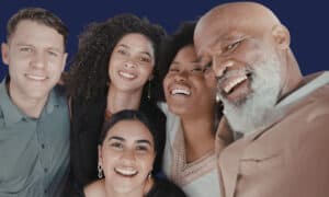 Diverse group of smiling adults of different ages showing healthy, youthful smiles achieved through a dental facelift