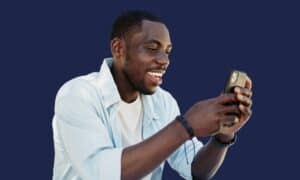 Man scrolling through viral dental hacks on his phone, why social media dental trends can damage your teeth