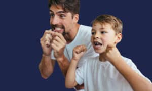 Man and young boy flossing their teeth together, flossing, interdental brushes, and cleaning between the teeth.